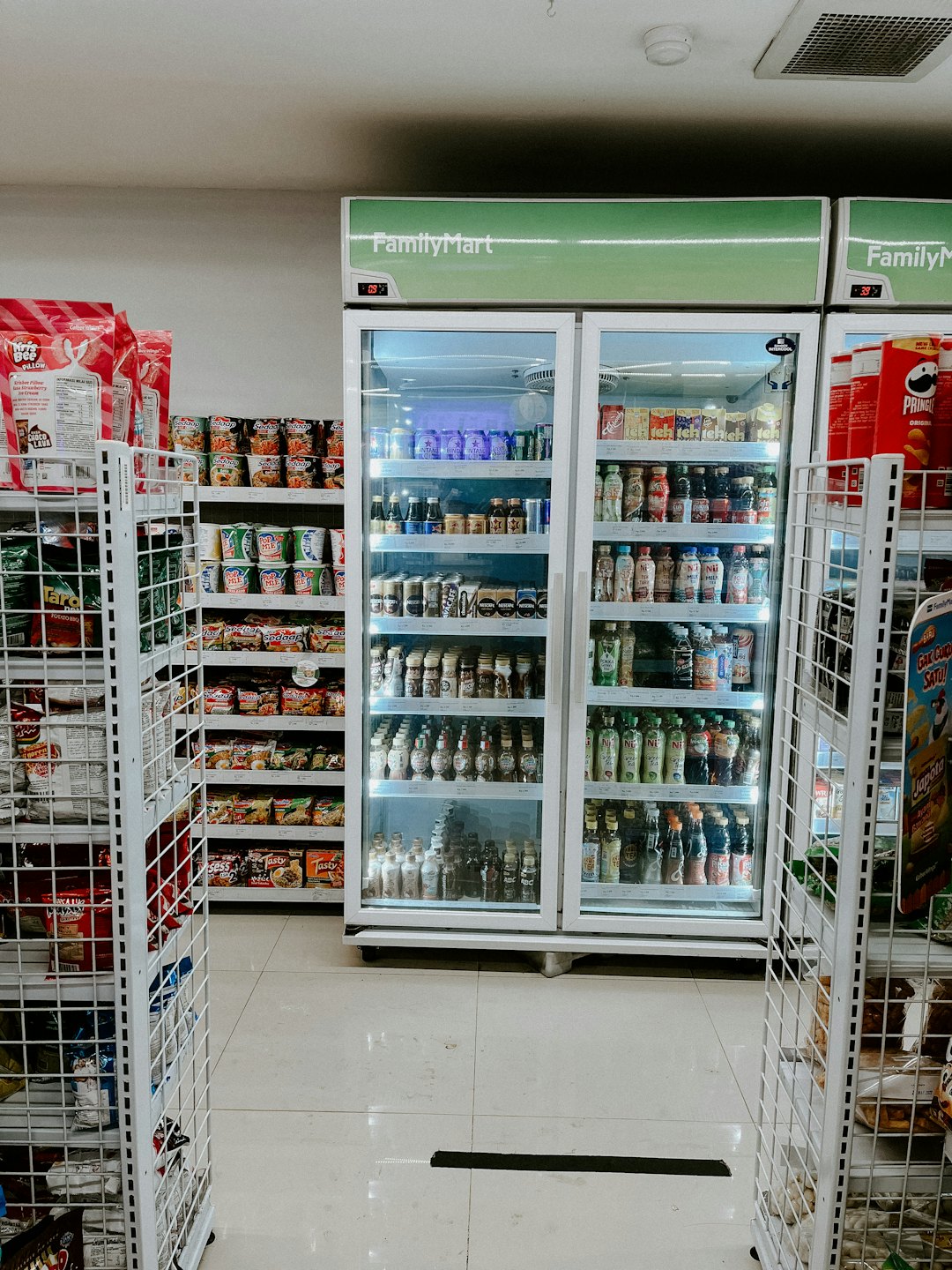 FamilyMart convenience store aisle with snacks and bottled drinks.